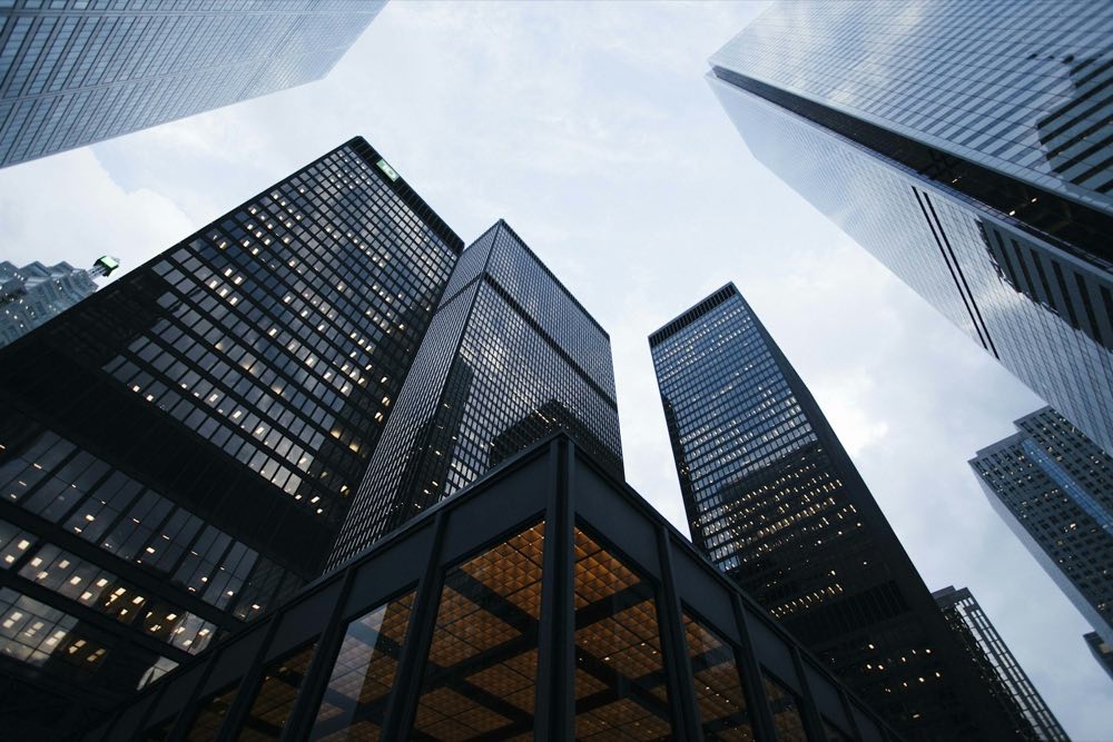 Looking up at high-rise towers towards the light